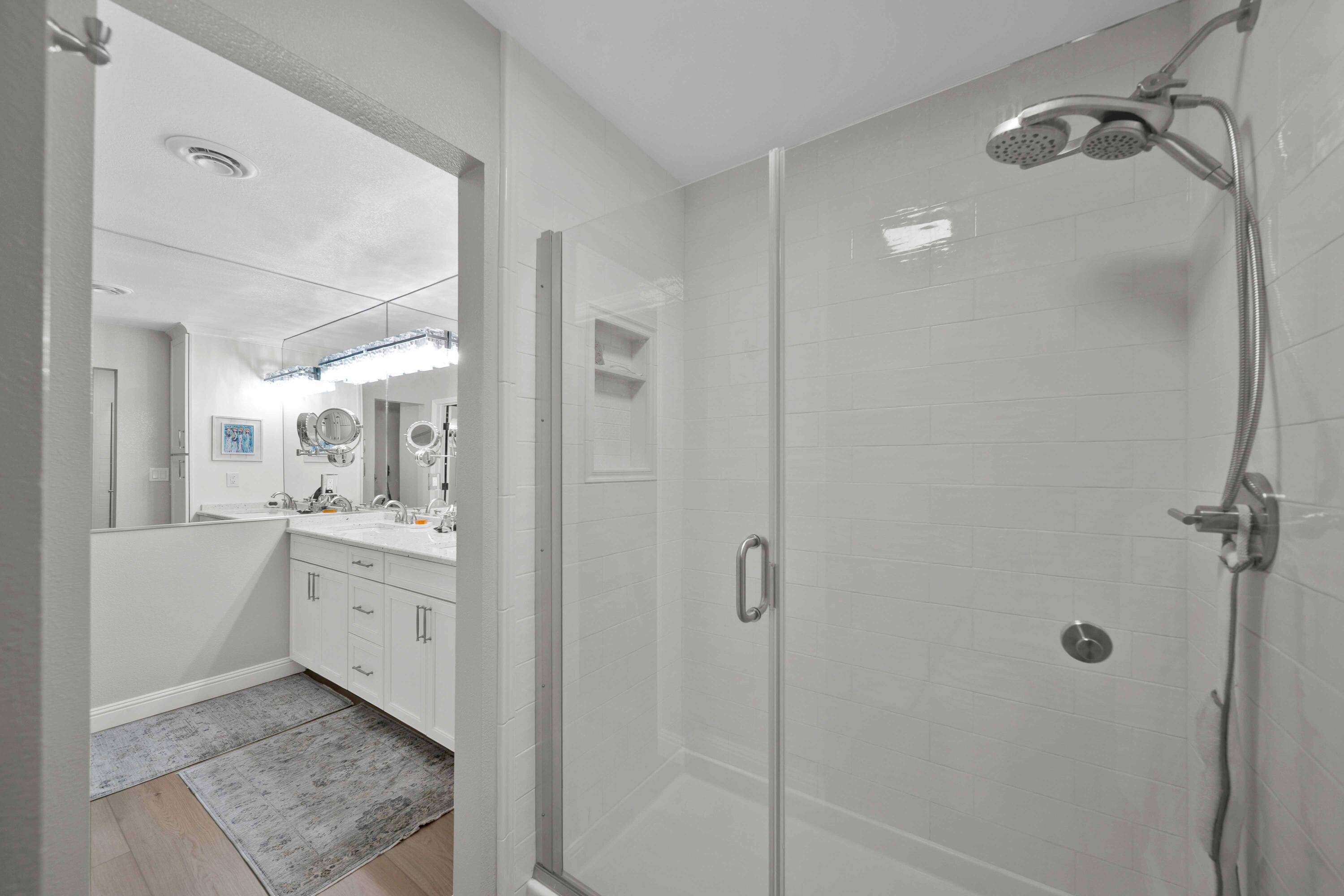 1928 Bechelli Lane Redding, CA 96002 - Photo 33 of 67 a bathroom with a granite countertop sink a mirror and shower