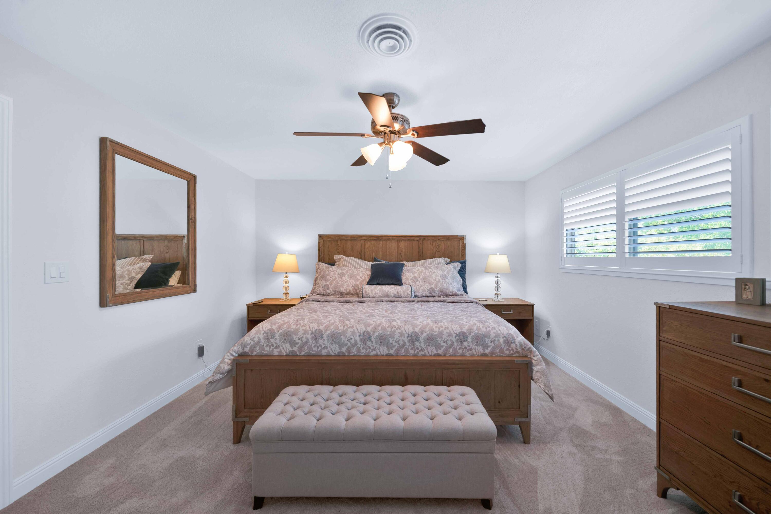 1928 Bechelli Lane Redding, CA 96002 - Photo 37 of 67 a bedroom with a bed and a chandelier