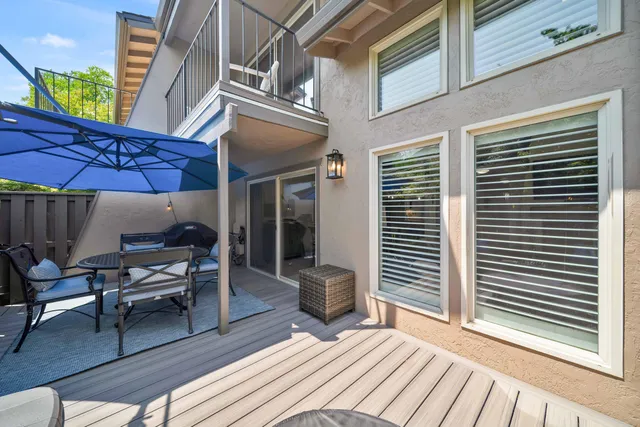 a view of a sitting area with swimming pool and green space