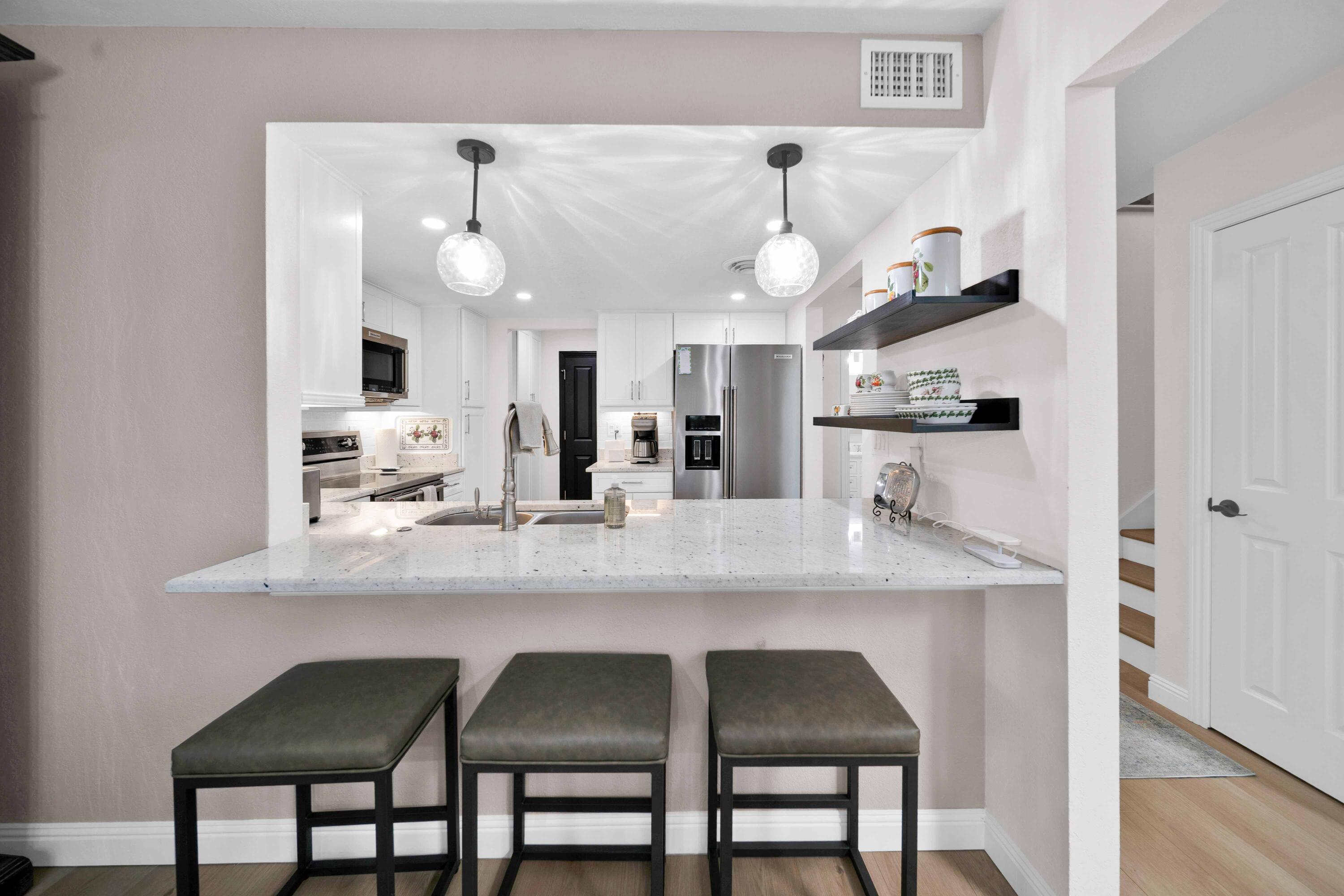 1928 Bechelli Lane Redding, CA 96002 - Photo 5 of 67 a kitchen with stainless steel appliances granite countertop a sink and a refrigerator