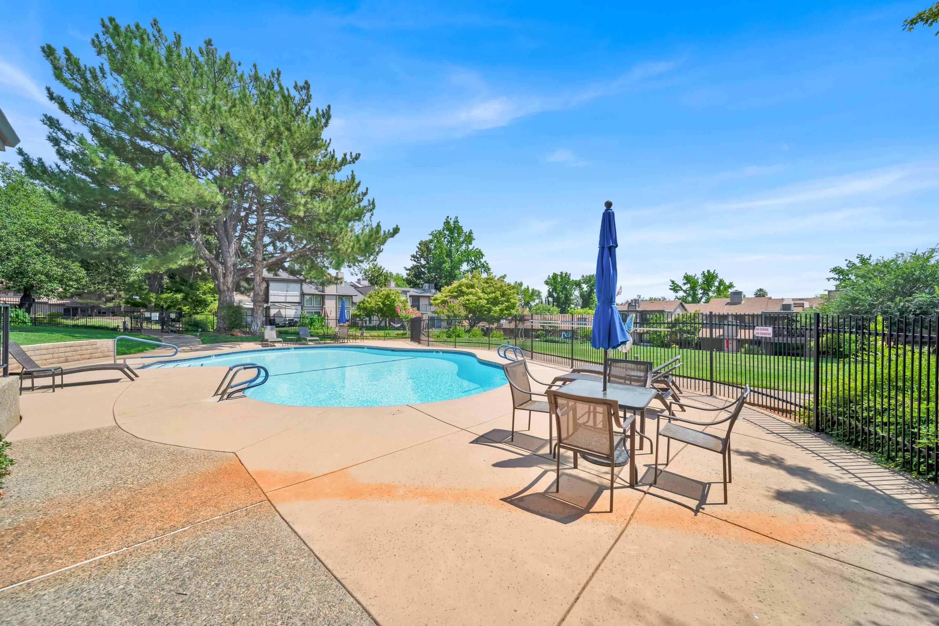 1928 Bechelli Lane Redding, CA 96002 - Photo 56 of 67 a view of a sitting area with swimming pool and green space
