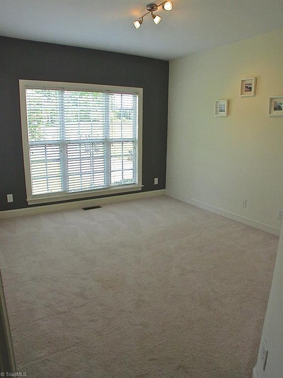 711 Number Ten Way Oak Ridge, NC 27310 - Photo 12 of 25 Great sized 5th bedroom on main level. It has its own private full bath.