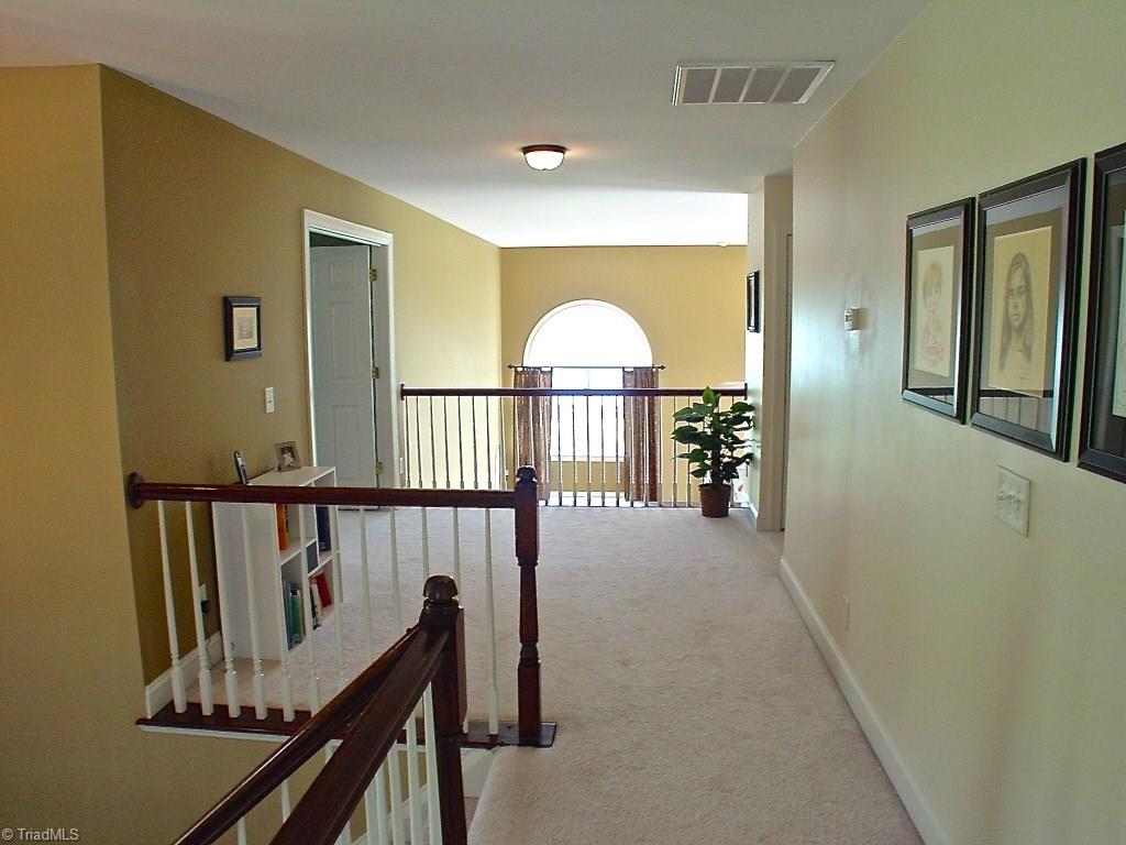 711 Number Ten Way Oak Ridge, NC 27310 - Photo 18 of 25 Wide open landing that overlooks Great room and moves through double doors into the Master bedroom.