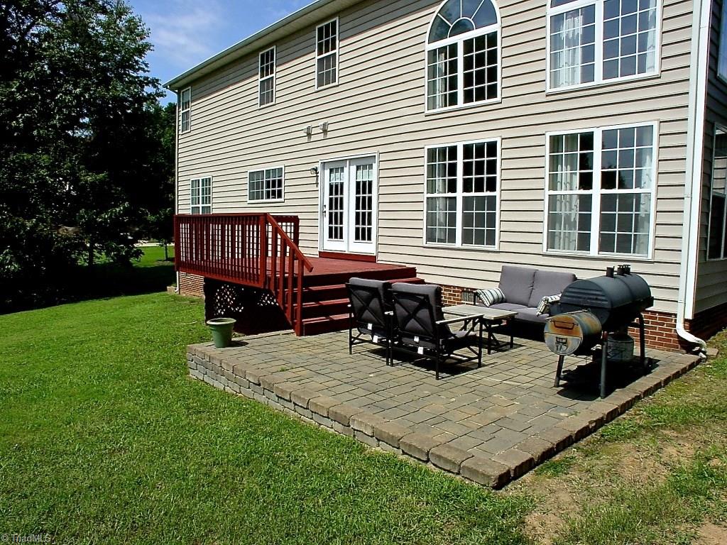 711 Number Ten Way Oak Ridge, NC 27310 - Photo 25 of 25 Freshly stained deck steps down to nice rough block patio. Wonderful outdoor space to enjoy year round.