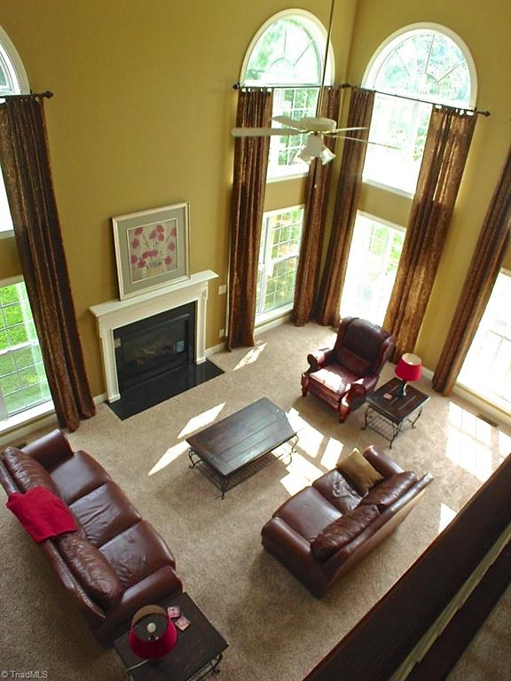 711 Number Ten Way Oak Ridge, NC 27310 - Photo 8 of 25 Beautiful Great room with high ceilings, arch top windows and gas fireplace.