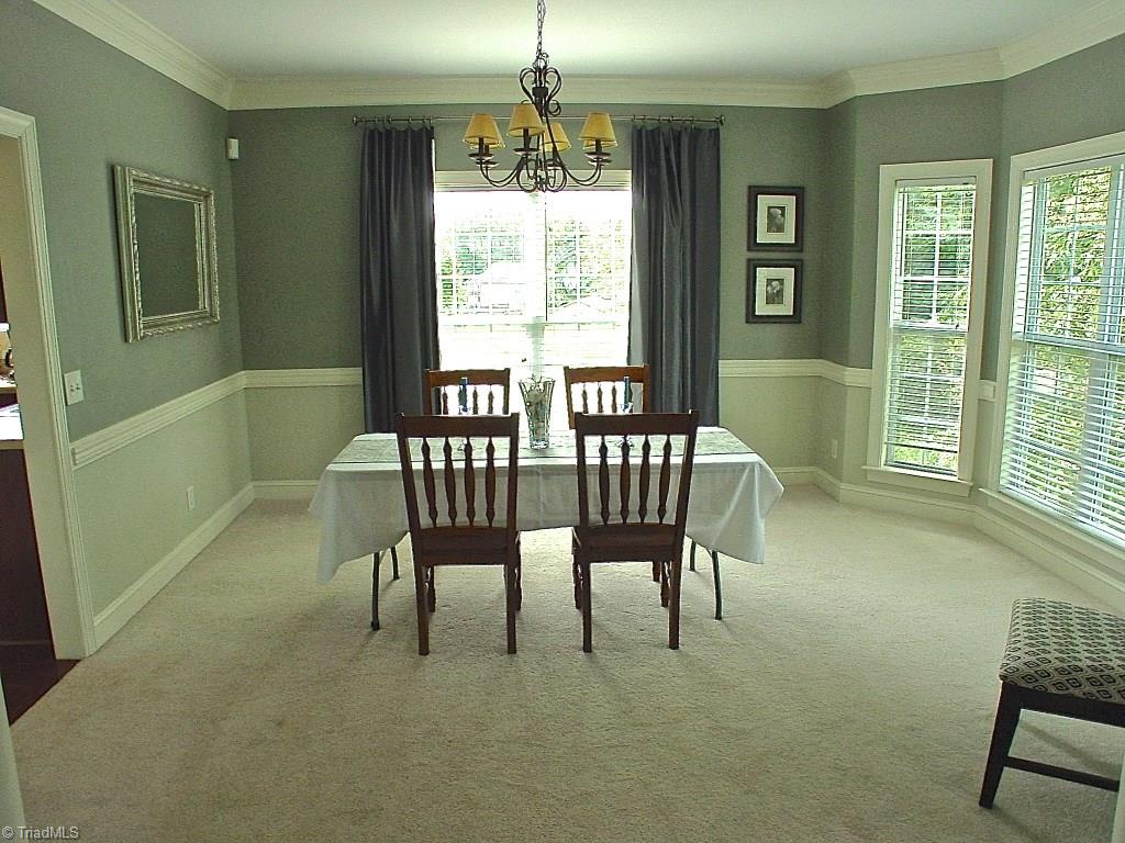711 Number Ten Way Oak Ridge, NC 27310 - Photo 9 of 25 Dining Room has nice bright windows and is open to the Living room. Nice Chair Rail and Crown moldings.