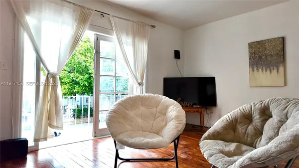 a living room with furniture and a large window