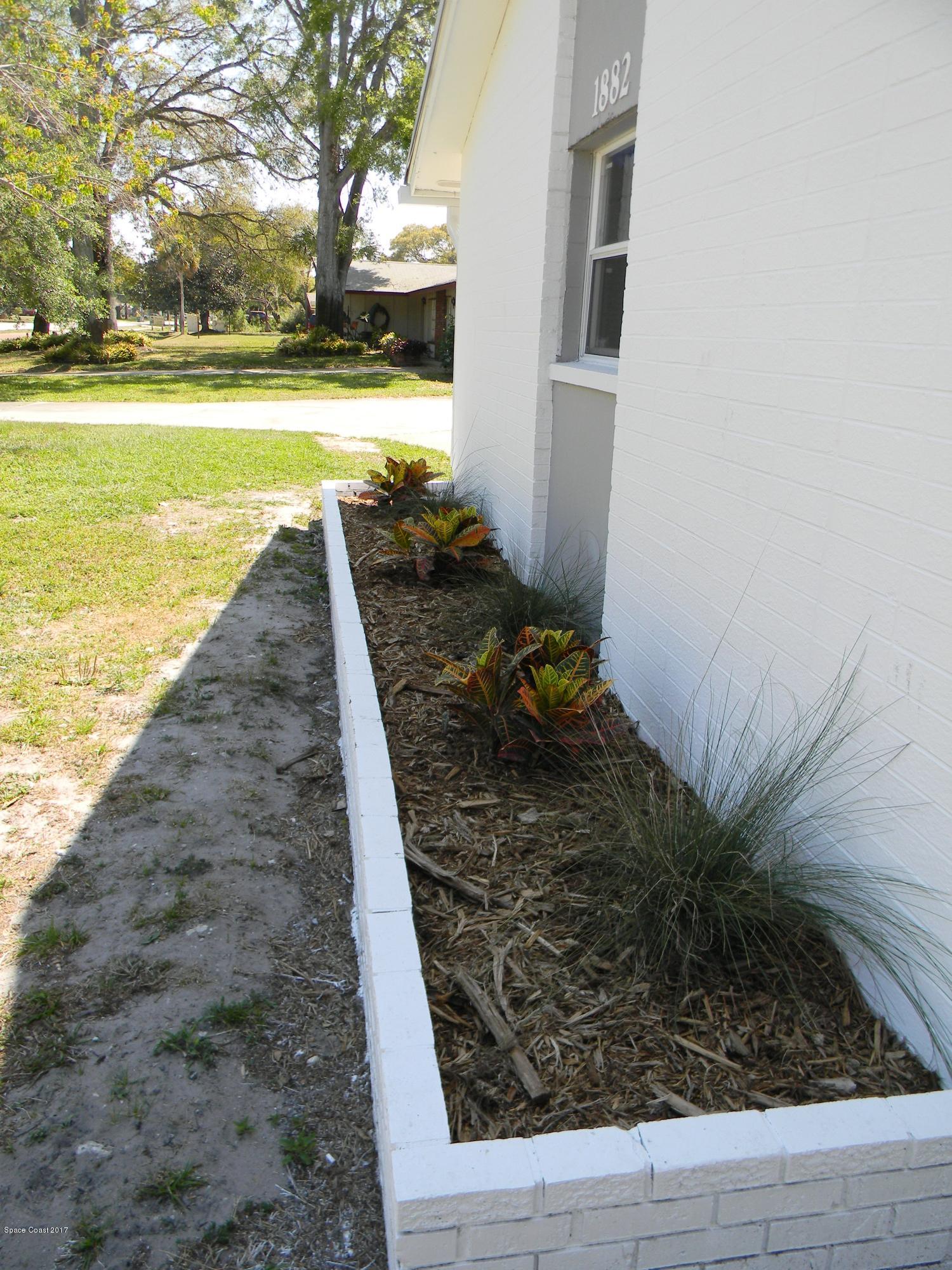 1882 North Carpenter Road Titusville, FL 32796 - Photo 24 of 39 LANDSCAPING IN FRONT OF HOUSE