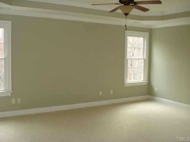 2106 Cook Ridge Court Raleigh, NC 27615 - Photo 8 of 11 an empty room with a window and a ceiling fan