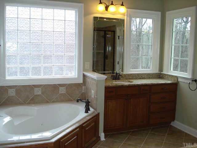 2106 Cook Ridge Court Raleigh, NC 27615 - Photo 9 of 11 a bathroom with a sink and a bathtub