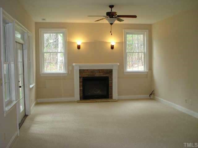 2106 Cook Ridge Court Raleigh, NC 27615 - Photo 10 of 11 an empty room with windows and fireplace