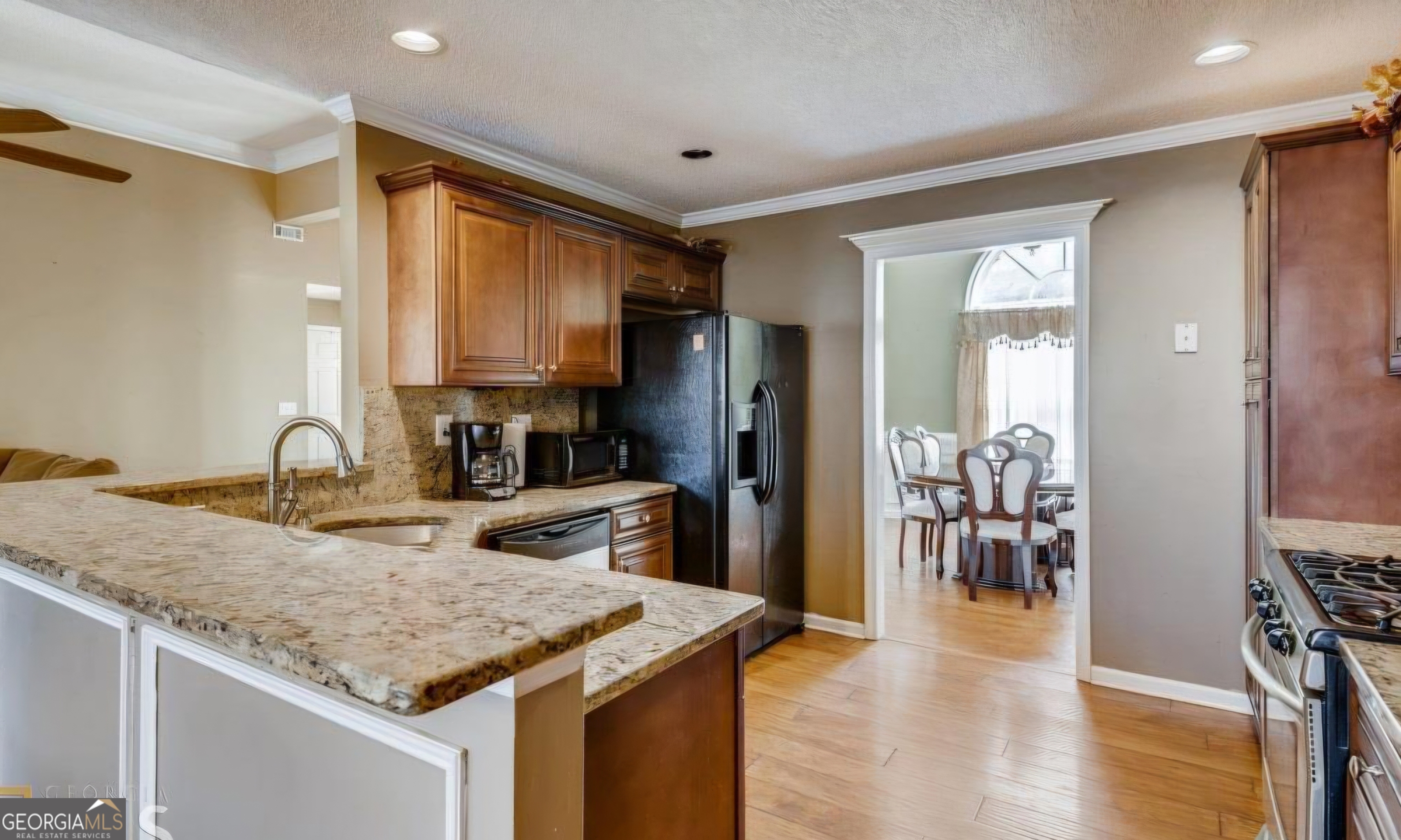 150 Stephanie Lane Covington, GA 30016 - Photo 2 of 3 a kitchen with a refrigerator a sink and a stove