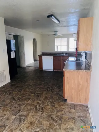 a view of a kitchen with a sink and a wooden floor