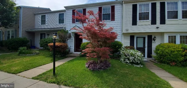 a front view of house and yard with green space