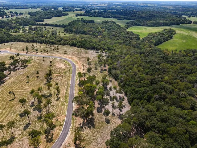 a view of a yard with wooden fence
