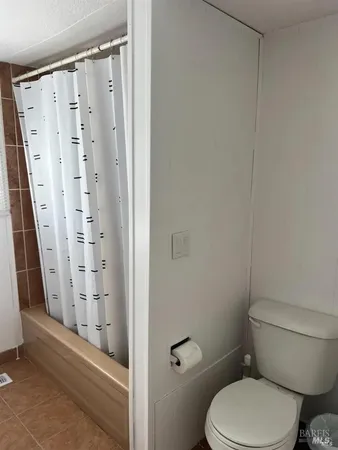 a white toilet sitting next to a bathroom sink