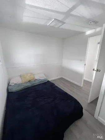 a bedroom with a bed and a night stand