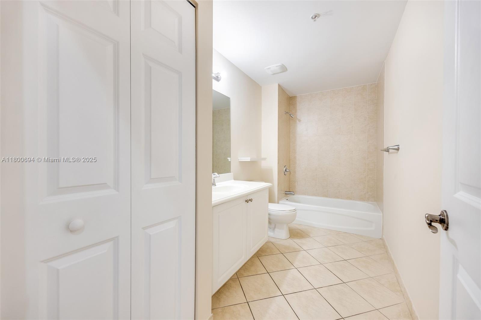 8395 Southwest 73rd Avenue, Unit 320 Miami, FL 33143 - Photo 12 of 18 a bathroom with a sink a toilet and shower