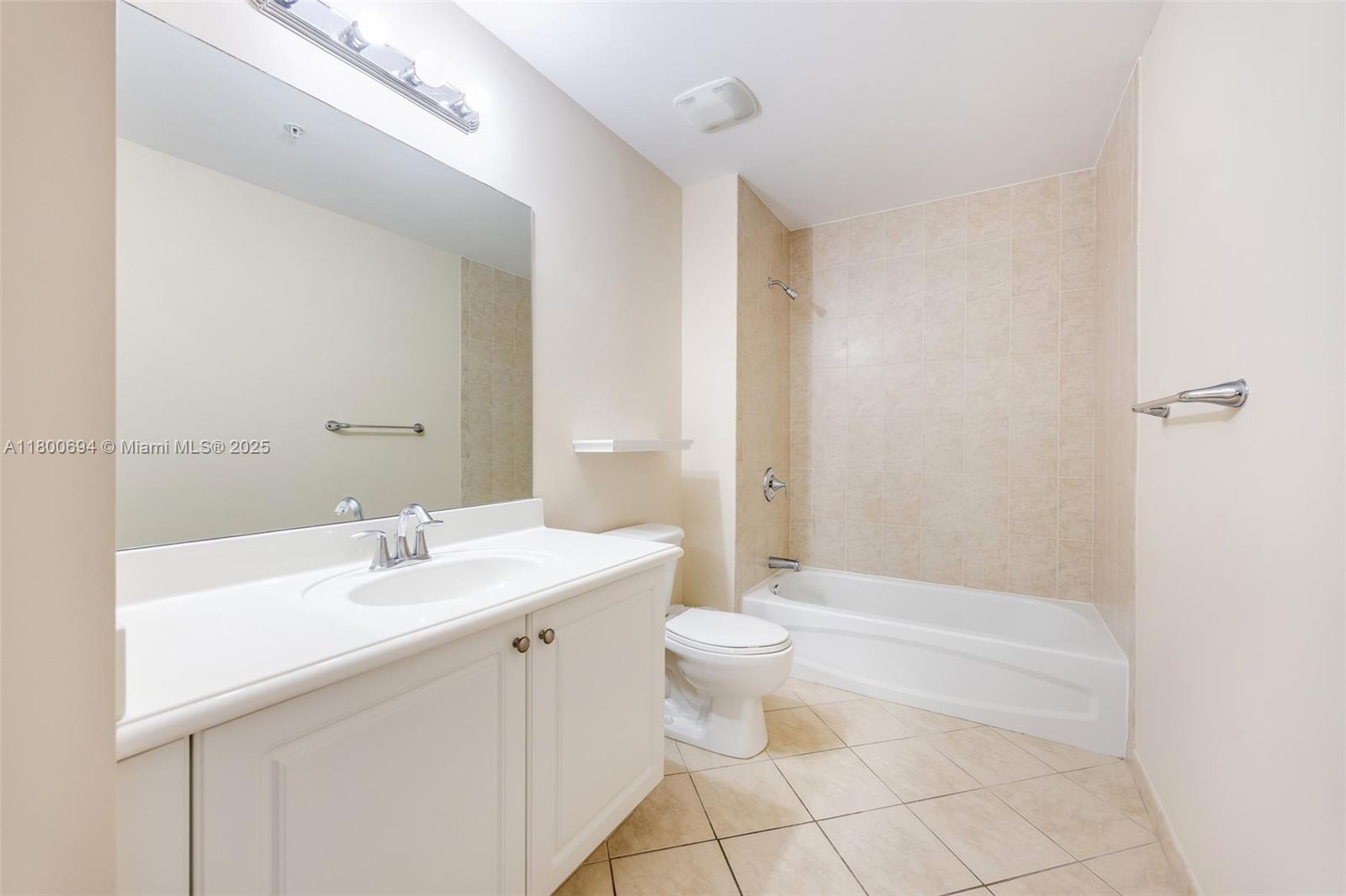 8395 Southwest 73rd Avenue, Unit 320 Miami, FL 33143 - Photo 13 of 18 a bathroom with a sink a toilet and shower