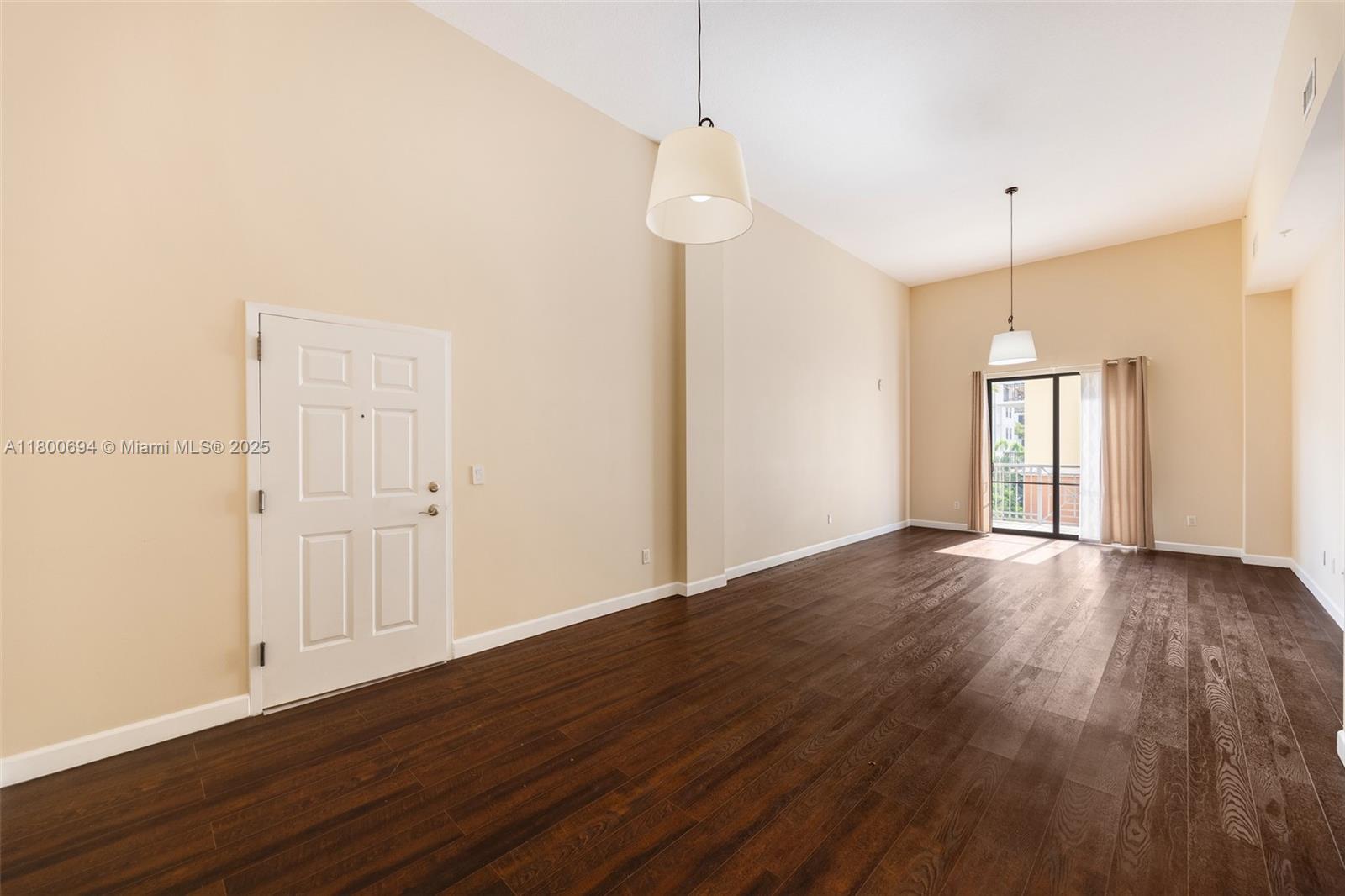 8395 Southwest 73rd Avenue, Unit 320 Miami, FL 33143 - Photo 3 of 18 a view of empty room with wooden floor and fan