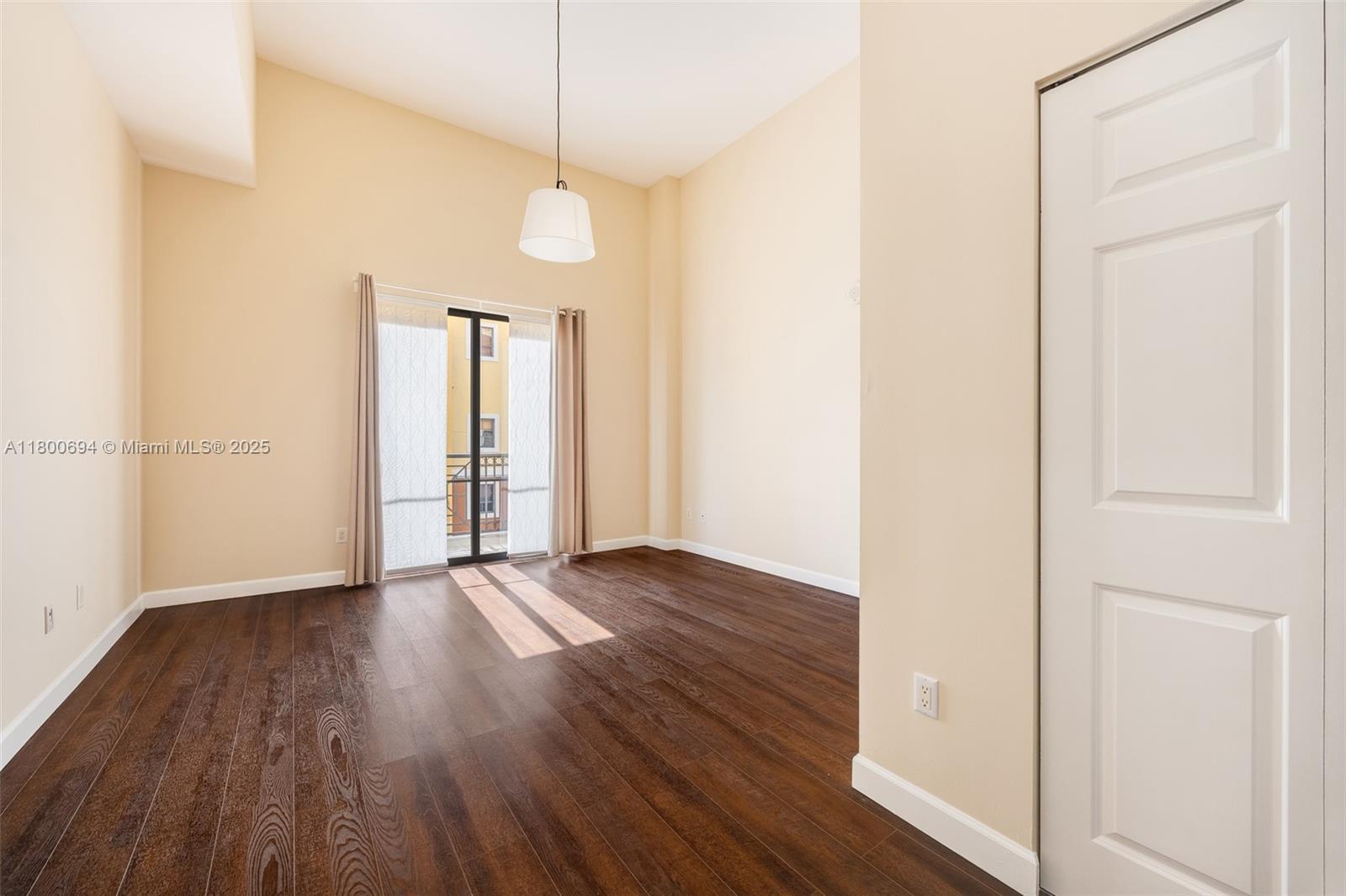 8395 Southwest 73rd Avenue, Unit 320 Miami, FL 33143 - Photo 8 of 18 an empty room with wooden floor and windows