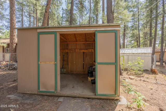 a view of a house with a door and wooden bench