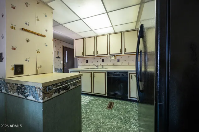 a kitchen with kitchen island a sink stainless steel appliances granite countertop a stove a refrigerator and cabinets