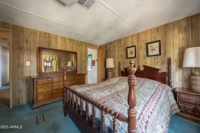 a bed room with a bed and dresser