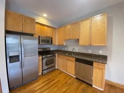 a kitchen with granite countertop stainless steel appliances and cabinets