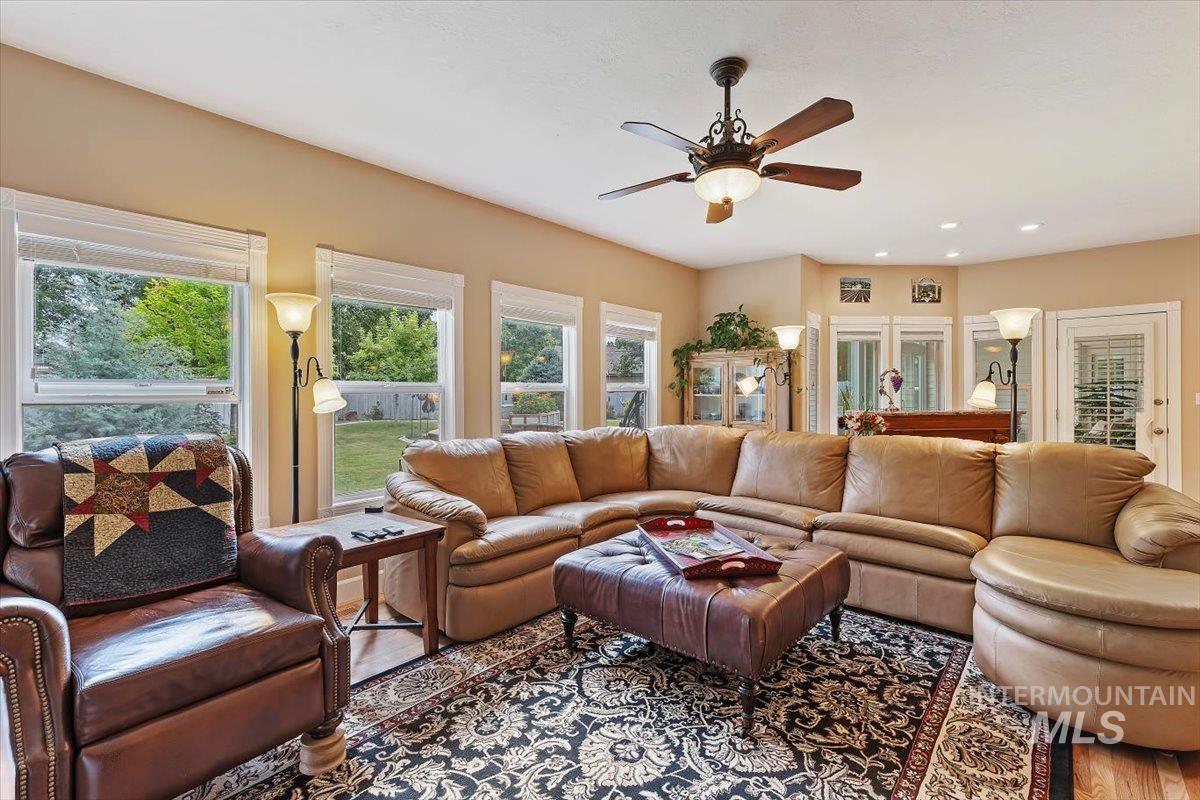 5184 North Greyloch Way Boise, ID 83704 - Photo 9 of 32 Spacious living area featuring light-toned walls, multiple windows, and a ceiling fan with integrated lighting