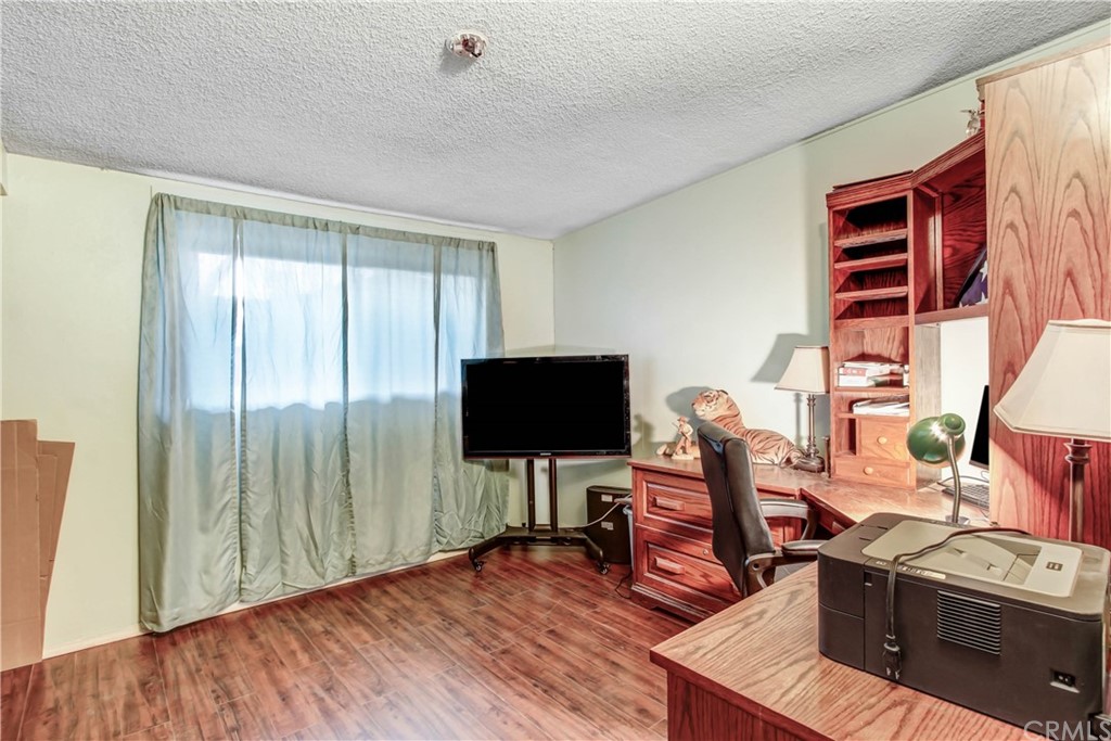 61495 La Jolla Drive Joshua Tree, CA 92252 - Photo 11 of 21 a view of a workspace with furniture and wooden floor