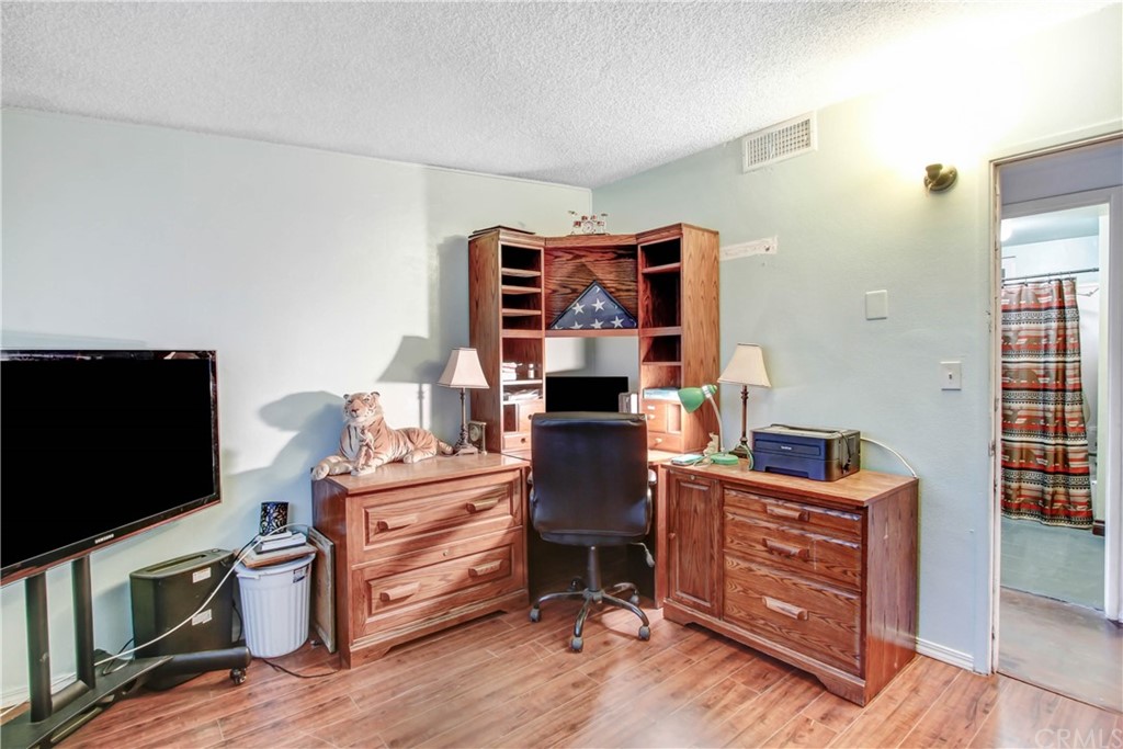 61495 La Jolla Drive Joshua Tree, CA 92252 - Photo 12 of 21 a room with furniture and a flat screen tv