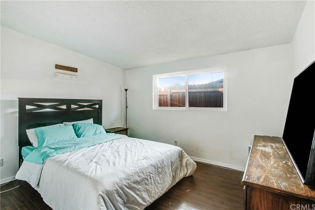 61495 La Jolla Drive Joshua Tree, CA 92252 - Photo 13 of 21 a bedroom with a bed and wooden floor