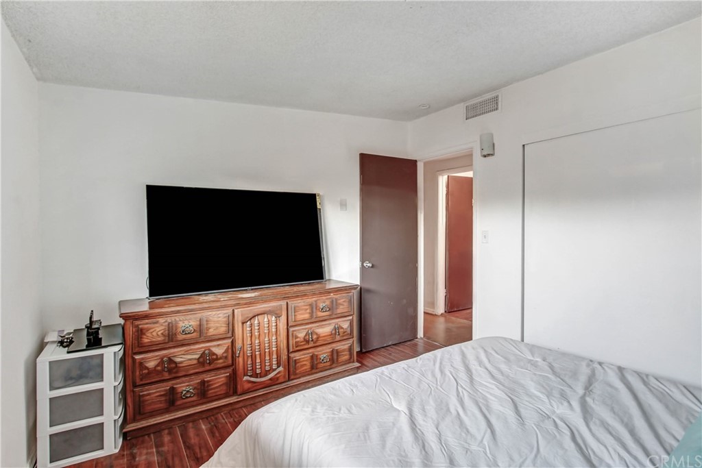 61495 La Jolla Drive Joshua Tree, CA 92252 - Photo 14 of 21 a bedroom with a bed and a flat screen tv