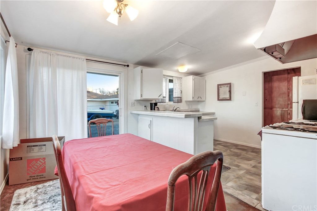 61495 La Jolla Drive Joshua Tree, CA 92252 - Photo 5 of 21 a kitchen with kitchen island a sink stove and refrigerator