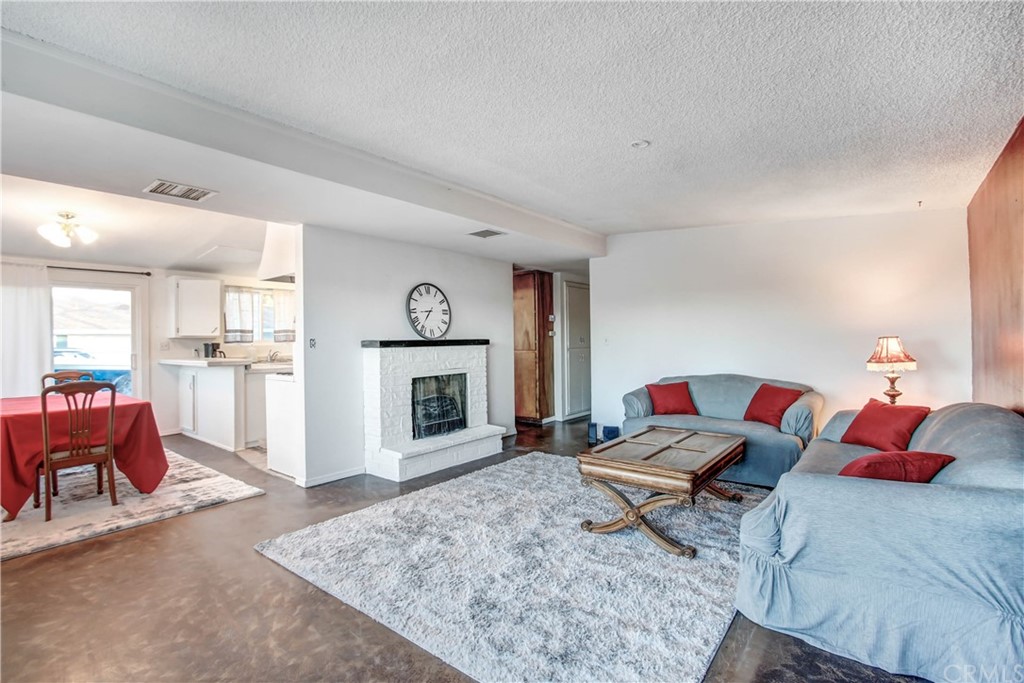 61495 La Jolla Drive Joshua Tree, CA 92252 - Photo 6 of 21 a living room with furniture and a fireplace