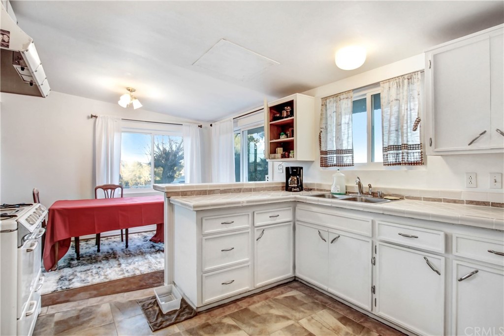 61495 La Jolla Drive Joshua Tree, CA 92252 - Photo 8 of 21 a kitchen with a sink cabinets and wooden floor