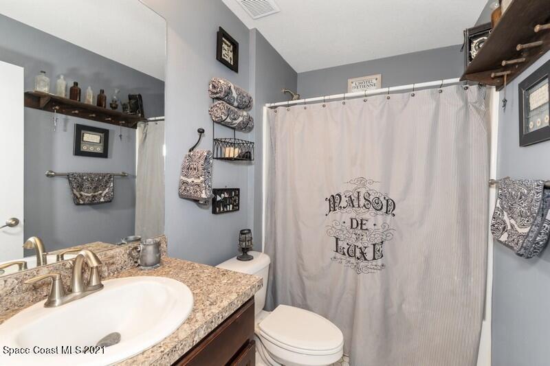 1808 Holbrook Road Northwest Palm Bay, FL 32907 - Photo 12 of 28 a bathroom with a granite countertop sink toilet and shower