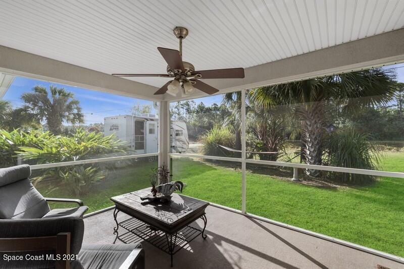 1808 Holbrook Road Northwest Palm Bay, FL 32907 - Photo 14 of 28 a view of a porch with furniture and a yard
