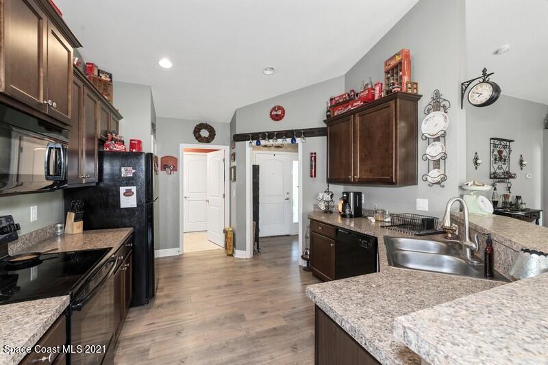 1808 Holbrook Road Northwest Palm Bay, FL 32907 - Photo 5 of 28 a kitchen with granite countertop lots of counter top space and stainless steel appliances
