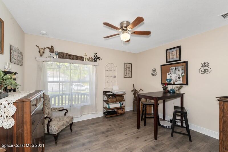 1808 Holbrook Road Northwest Palm Bay, FL 32907 - Photo 7 of 28 a workspace with wooden floor and a window