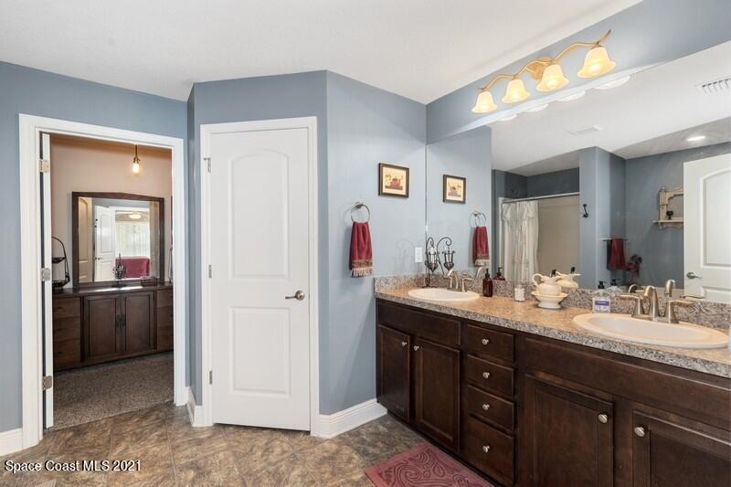 1808 Holbrook Road Northwest Palm Bay, FL 32907 - Photo 9 of 28 a bathroom with a sink vanity and mirror