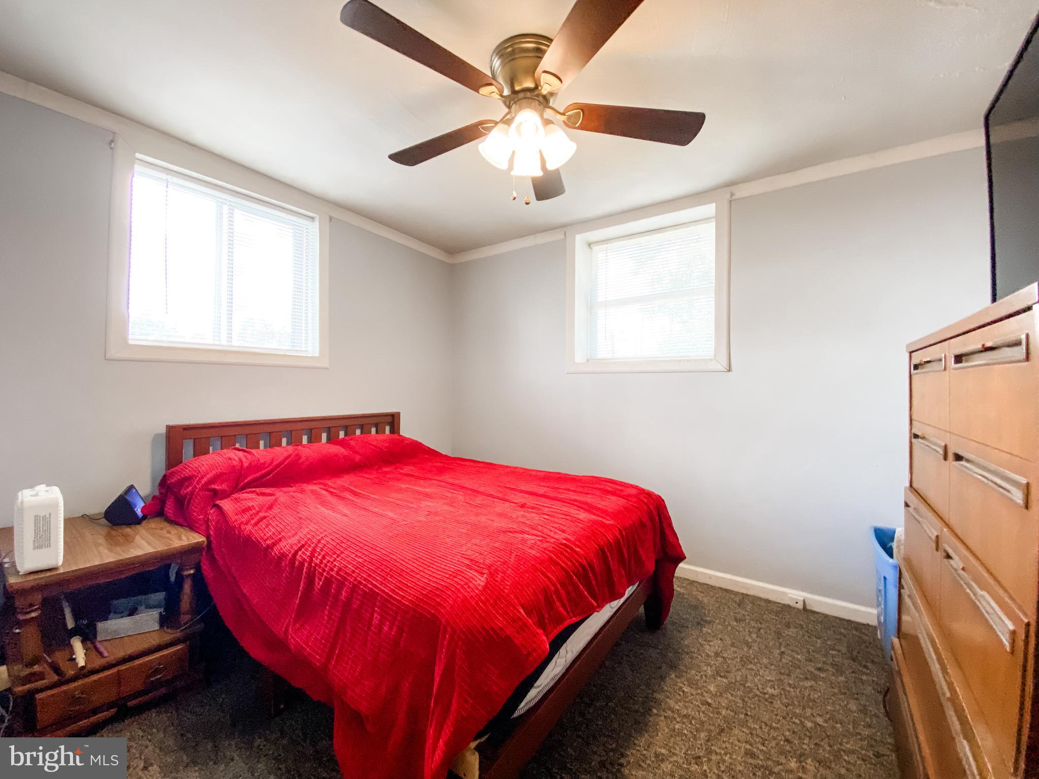 3743 Chestnut Ridge Road Grantsville, MD 21536 - Photo 6 of 14 a bed sitting in a bedroom next to a window
