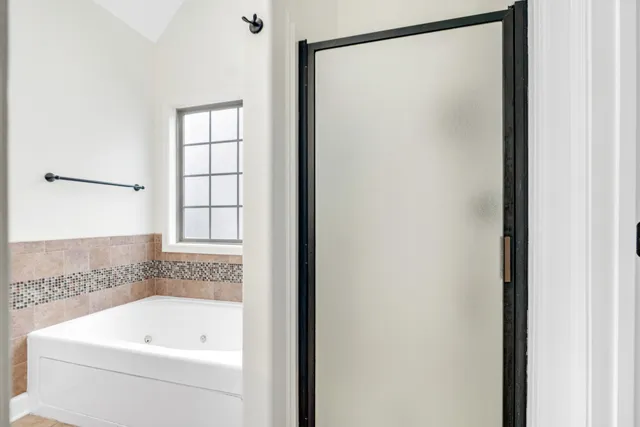 a bathroom with a bathtub and a shower