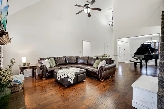 a living room with furniture and wooden floor