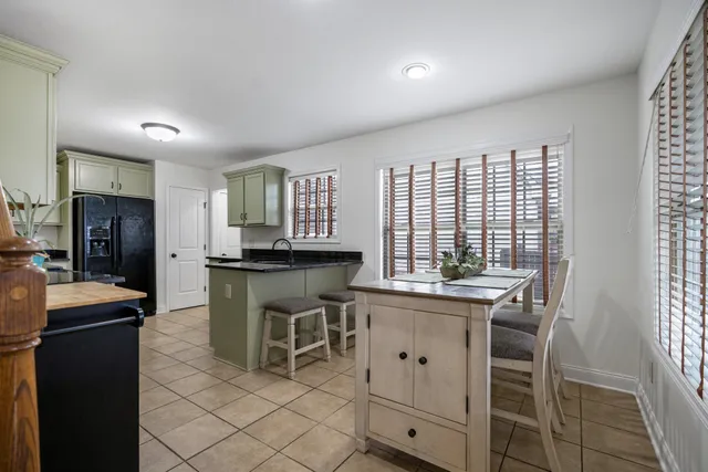 a kitchen with cabinets and chairs