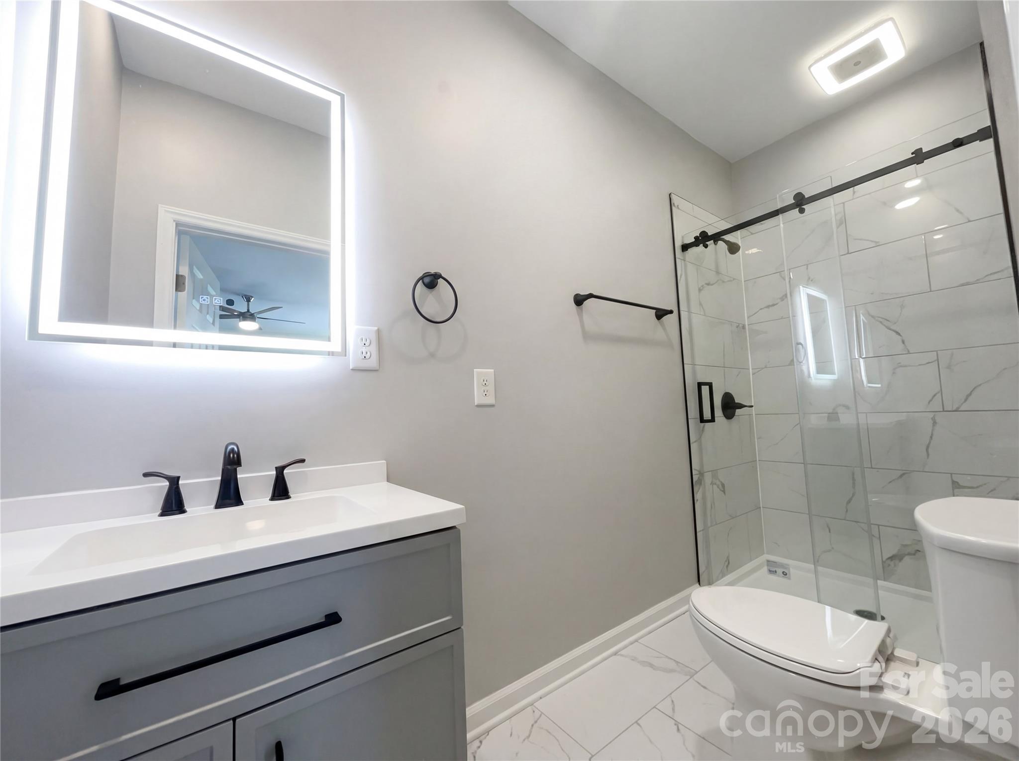405 Isle Of Pines Road Mooresville, NC 28117 - Photo 13 of 18 a bathroom with a sink a toilet and shower