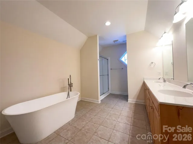 a bathroom with a bathtub and shower