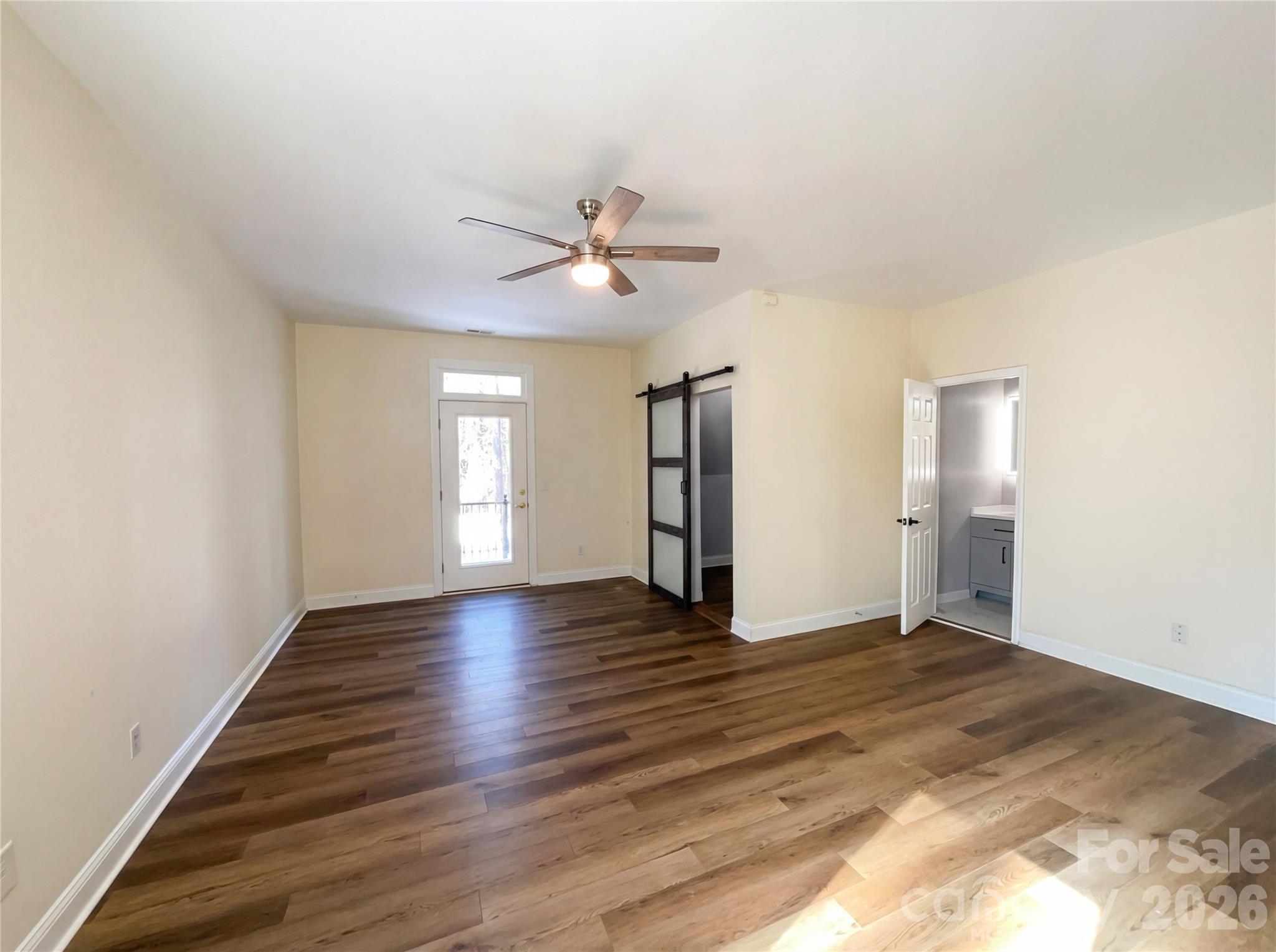 405 Isle Of Pines Road Mooresville, NC 28117 - Photo 4 of 18 a view of an empty room with window and wooden floor