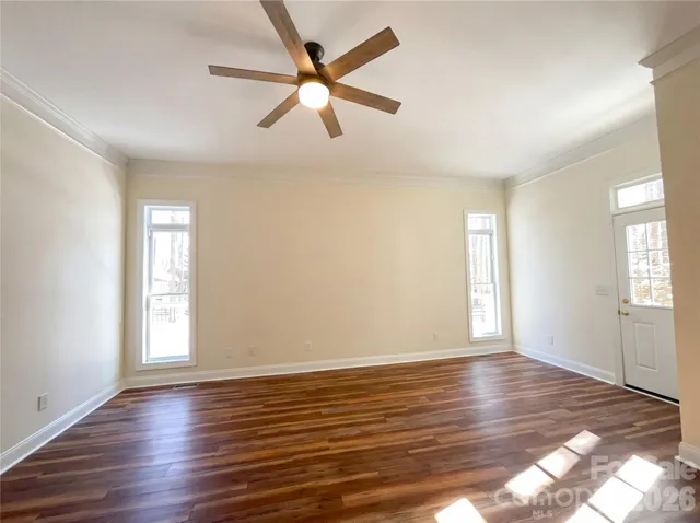 wooden floor in an empty room with a window